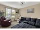 Cozy living room featuring neutral walls, a comfortable sectional, and ample natural light from large windows at 13728 Oliver Ln, Carmel, IN 46074