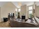 Open-concept living room boasts high ceilings, a fireplace, large windows, and a comfortable seating arrangement at 13728 Oliver Ln, Carmel, IN 46074