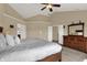 Large main bedroom with vaulted ceilings, a dresser, and an en-suite bathroom, the perfect space for rest and relaxation at 13728 Oliver Ln, Carmel, IN 46074