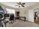 Spacious home office with an elliptical machine, a computer desk, and a built-in bookcase, offering a productive workspace at 13728 Oliver Ln, Carmel, IN 46074