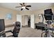 Bright office with a ceiling fan and a view of the backyard, complete with a desk, piano and exercise machine at 13728 Oliver Ln, Carmel, IN 46074