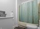 Bathroom with new flooring, new paint, trim, modern sink, and a shower with a geometric curtain at 1401 E 24Th St, Muncie, IN 47302