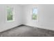Bright bedroom featuring two large windows and neutral carpeting at 1401 E 24Th St, Muncie, IN 47302