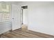 Bright bedroom featuring wood-look flooring, white walls, and window with blinds at 1401 E 24Th St, Muncie, IN 47302