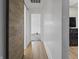 Hallway with hardwood flooring and access to multiple rooms at 1401 E 24Th St, Muncie, IN 47302