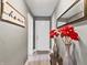 View of the charming hallway with decor, lighting, and a wooden 'home sweet home' sign on the wall at 1401 E 24Th St, Muncie, IN 47302