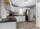 Galley kitchen featuring white cabinets, stainless steel appliances, and vinyl flooring at 1401 E 24Th St, Muncie, IN 47302