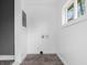 Bright laundry room featuring new tile flooring, white walls and window providing natural light at 1401 E 24Th St, Muncie, IN 47302