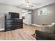 Living room featuring hardwood floors, lighting, a window, and access to the kitchen at 1401 E 24Th St, Muncie, IN 47302
