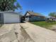 The house features a detached garage and a cracked concrete driveway at 1401 W 34Th St, Indianapolis, IN 46208