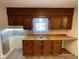 Cozy kitchen with wooden cabinets and countertop, double sink, and small eating area at 1401 W 34Th St, Indianapolis, IN 46208