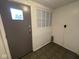 Small, functional mud room features a window and door leading to the exterior at 1401 W 34Th St, Indianapolis, IN 46208