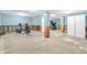 Unfinished basement with concrete floor, visible framework, and a workout area at 15329 Smithfield Dr, Westfield, IN 46074