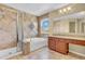 Elegant primary bathroom featuring tiled floors, walk-in shower, and large soaking tub with a garden window at 15329 Smithfield Dr, Westfield, IN 46074