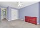 Bedroom featuring neutral carpet, a ceiling fan, and a red dresser near a closet at 15329 Smithfield Dr, Westfield, IN 46074