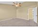 Bright bedroom features neutral carpet, ceiling fan, and doorway for convenient access at 15329 Smithfield Dr, Westfield, IN 46074
