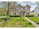 Two-story brick home with a manicured lawn, sidewalk and front garden at 15329 Smithfield Dr, Westfield, IN 46074