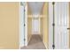 Inviting hallway with neutral carpet and light yellow walls leading to various rooms in the home at 15329 Smithfield Dr, Westfield, IN 46074