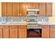 Close-up of kitchen featuring stainless steel appliances, granite countertops, and custom cabinets at 15329 Smithfield Dr, Westfield, IN 46074