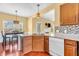 Kitchen featuring custom cabinets, granite counters, and a view of the dining and living areas at 15329 Smithfield Dr, Westfield, IN 46074