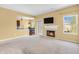 Open living room featuring a fireplace, view of the kitchen, and access to a patio at 15329 Smithfield Dr, Westfield, IN 46074