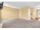 Open living room featuring neutral carpet, tan walls, and a staircase leading to the upper level at 15329 Smithfield Dr, Westfield, IN 46074