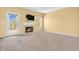 Spacious living room with a cozy fireplace, neutral carpet, and abundant natural light at 15329 Smithfield Dr, Westfield, IN 46074