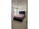 Bedroom features a queen-size bed with a decorative chandelier and a large bright window at 15406 Forest Glade Dr, Fishers, IN 46037