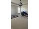 Spacious bedroom with carpet flooring, a modern light fixture, and a window overlooking the yard at 15406 Forest Glade Dr, Fishers, IN 46037