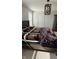 A bedroom with a large bed, overhead modern light fixture and a window with natural light at 15406 Forest Glade Dr, Fishers, IN 46037