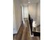 Hallway with wood flooring, white walls, and a black railing, leading to an upstairs area at 15406 Forest Glade Dr, Fishers, IN 46037
