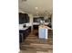 Open-concept kitchen featuring dark cabinets, a large island, and modern lighting at 15406 Forest Glade Dr, Fishers, IN 46037