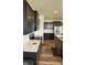 Stylish kitchen showcasing dark cabinets, marble countertops, and stainless steel appliances at 15406 Forest Glade Dr, Fishers, IN 46037