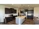 Spacious kitchen with dark wood cabinets, marble countertops, and stainless steel appliances at 15406 Forest Glade Dr, Fishers, IN 46037