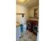 A laundry room featuring bold tile floors, ample counter space, and sleek red front-loading machines at 15406 Forest Glade Dr, Fishers, IN 46037