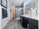 Bathroom with tiled floor, marble countertop, glass door shower, and modern fixtures at 1666 Huntzinger Blvd, Pendleton, IN 46064