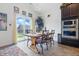Inviting dining area with a rustic wooden table, stylish chairs, and sliding door access to the yard at 1666 Huntzinger Blvd, Pendleton, IN 46064