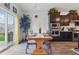 Cozy dining area with a wooden table, views to the outside, and adjacent kitchen space at 1666 Huntzinger Blvd, Pendleton, IN 46064