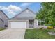 Charming single-story home with a two-car garage, manicured lawn, and lovely landscaping at 1666 Huntzinger Blvd, Pendleton, IN 46064