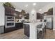 Well-equipped kitchen featuring stainless steel appliances, dark cabinetry, and a breakfast bar at 1666 Huntzinger Blvd, Pendleton, IN 46064