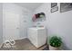 Bright laundry room with front load washer and dryer, shelving, and charming decor at 1666 Huntzinger Blvd, Pendleton, IN 46064