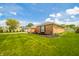 Side view of brick house with manicured lawn featuring dark mulch for landscaping at 1823 E 44Th St, Anderson, IN 46013