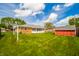 Large backyard with well maintained grass, a brick home, a shed, and a clothes line at 1823 E 44Th St, Anderson, IN 46013