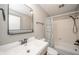 Clean bathroom with white vanity, decorative mirror, and shower/tub combination at 1823 E 44Th St, Anderson, IN 46013