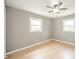 Bright bedroom features hardwood floors, neutral paint and a modern ceiling fan at 1823 E 44Th St, Anderson, IN 46013