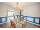 Bright dining room featuring a glass table, wood chairs, and a modern chandelier at 1823 E 44Th St, Anderson, IN 46013