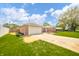 Well-maintained brick home with an attached garage and driveway, showcasing curb appeal at 1823 E 44Th St, Anderson, IN 46013