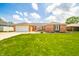 Charming brick home with a well-manicured lawn and attached garage, perfect for suburban living at 1823 E 44Th St, Anderson, IN 46013
