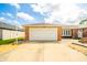 Spacious two-car garage with an extended driveway on a charming red brick house at 1823 E 44Th St, Anderson, IN 46013