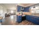 Charming kitchen with bold blue cabinets, stainless steel appliances, and butcher block countertops at 1823 E 44Th St, Anderson, IN 46013